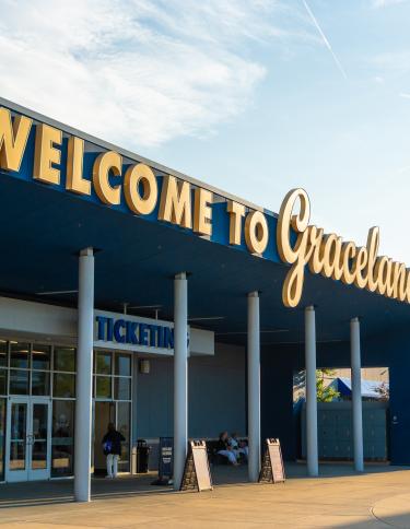 entrance to graceland exhibition center with "welcome to graceland" sign