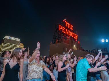 people dancing during Peabody rooftop party