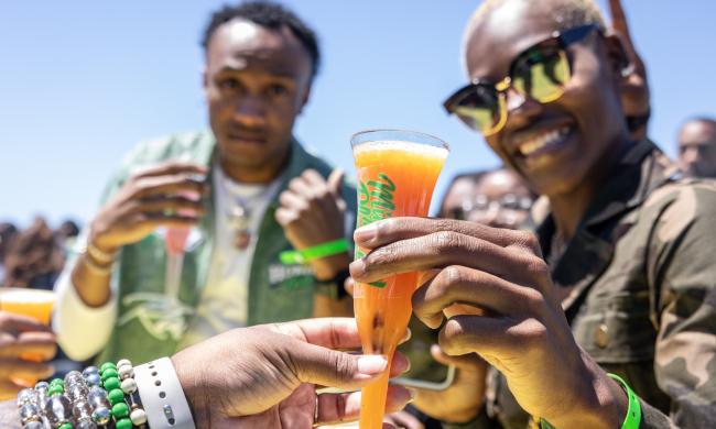 Two people enjoying mimosas at Mimosa Festival.