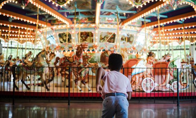 Child running towards the Grand Carousel at the Children's Museum of Memphis.