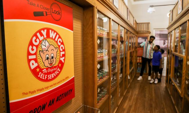 Museum goers inside the original Piggly Wiggly replica exhibit inside the Pink Palace Museum &amp; Mansion.