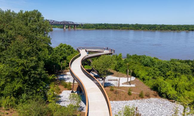 a 220-foot elevated walkway stretches over wetland and tree canopies looking out to the Mississippi River