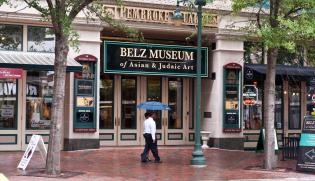 Tourists walk past the Belz Museum of Asian and Judaic art on Main Street in downtown Memphis Photo