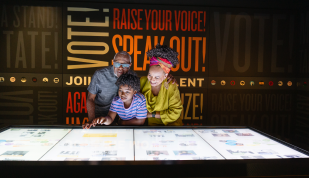A family explores an interactive exhibit at Memphis' National Civil Rights Museum.