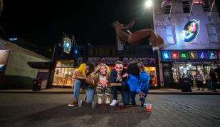 beale street flippers jump over group of friends