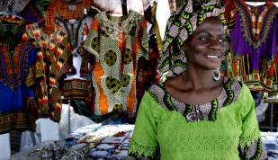 Woman in front of a booth at Africa in April Festival