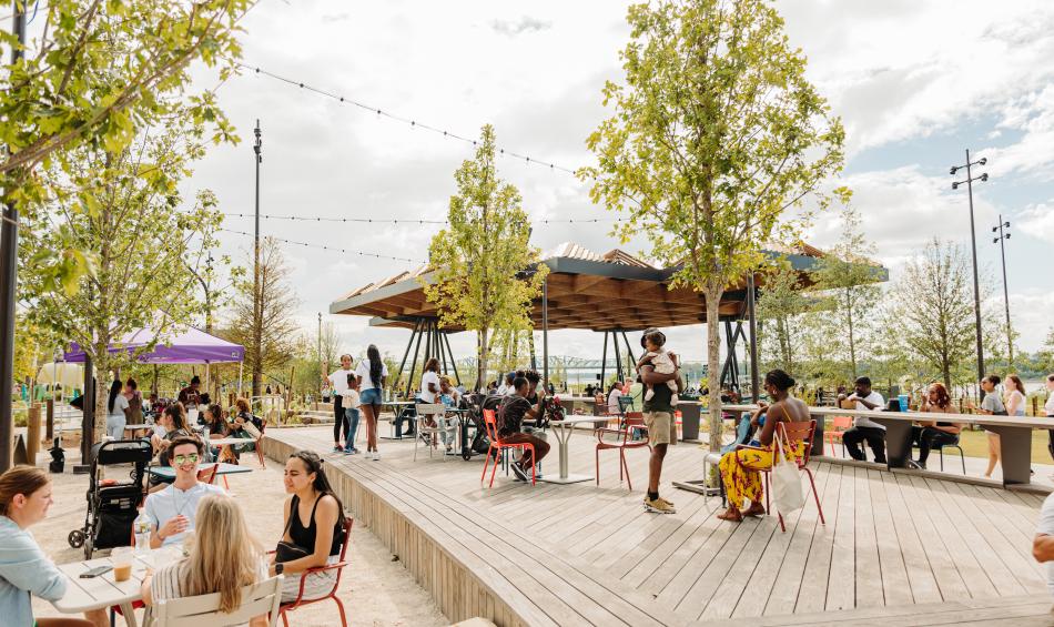 people gather at tables at Tom Lee Park