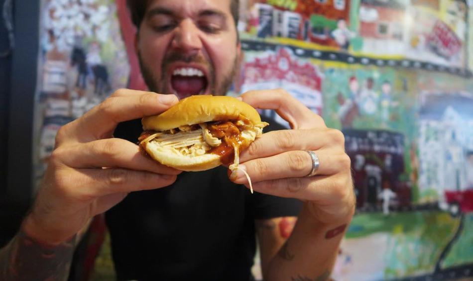 man eating BBQ Sandwich